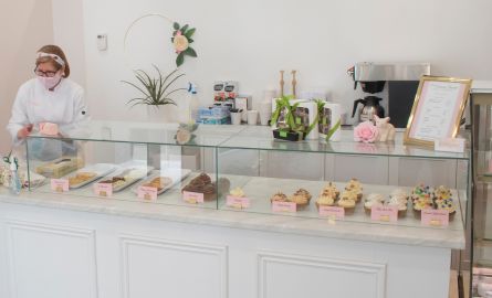 A front counter display with cupcakes and other baked goods.