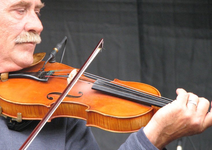 A man playing a fiddle.