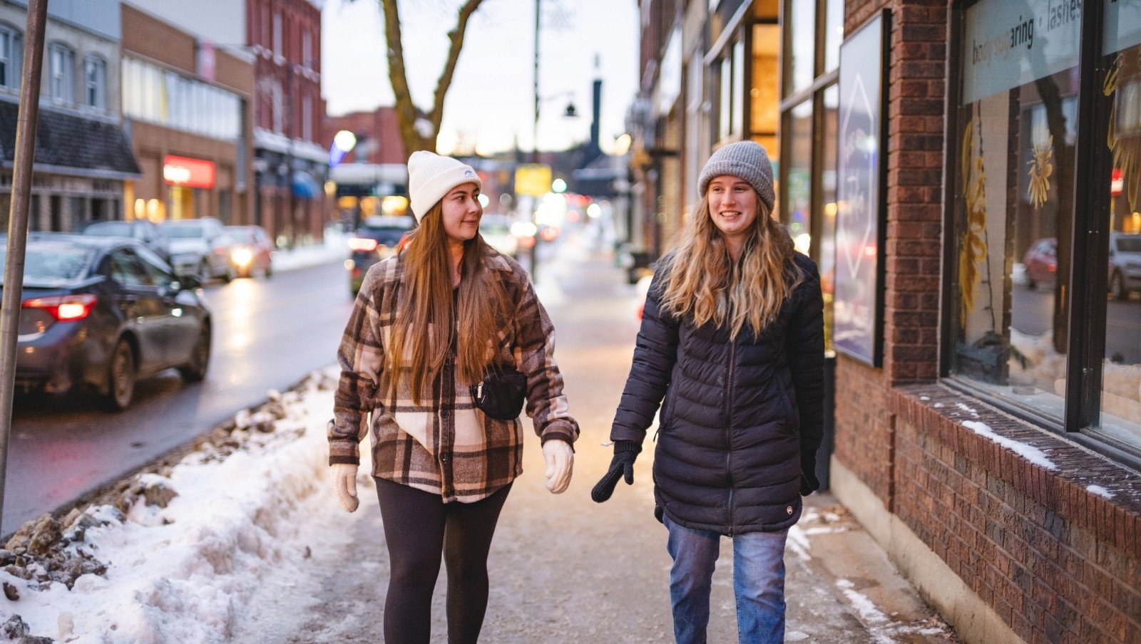 Two women walking in downtown Pembroke in winter.