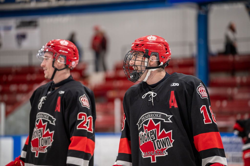 Two hockey players laughing together.