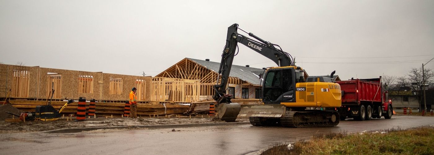Construction equipment outside a housing development.
