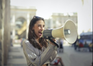 A woman talking into a megaphone.