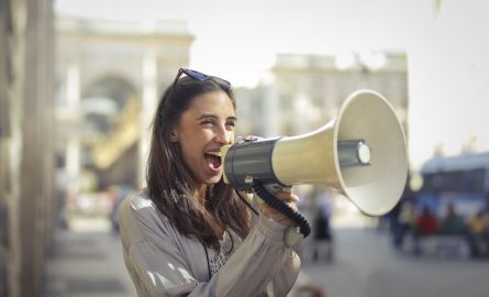 A woman talking into a megaphone.