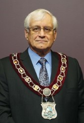 A person wearing mayoral sash 