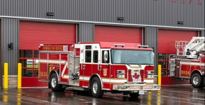 Photo of two fire trucks parked outside of Pembroke Fire Department