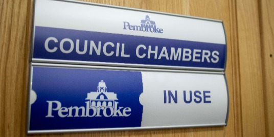 A photo of the Council Chambers doors.