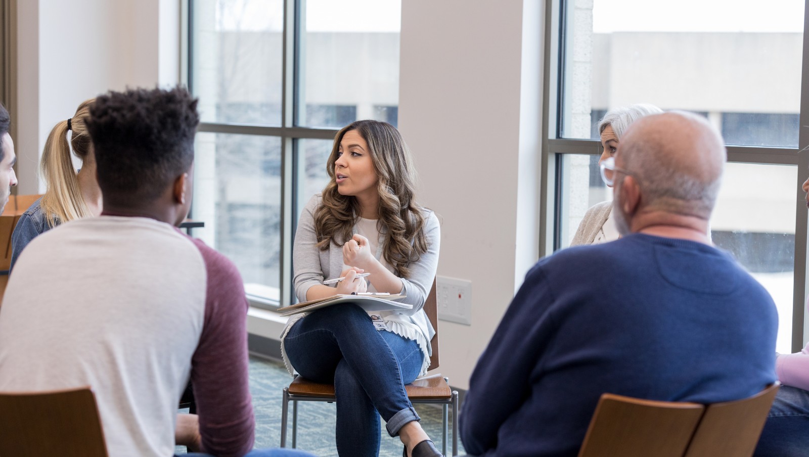 People sitting in a circle talking.