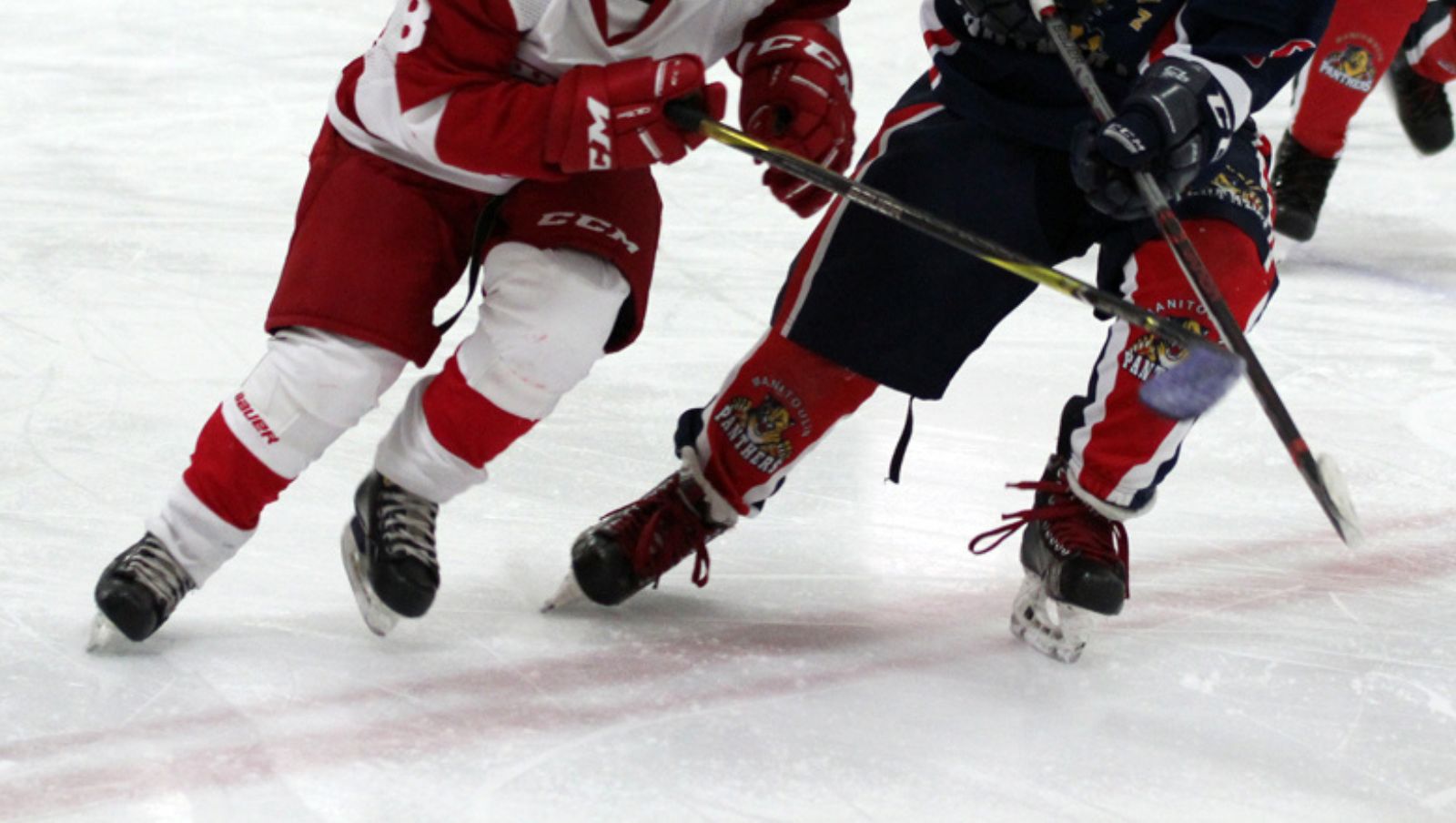 Children playing ice hockey on one side, a birthday cake on the other side.