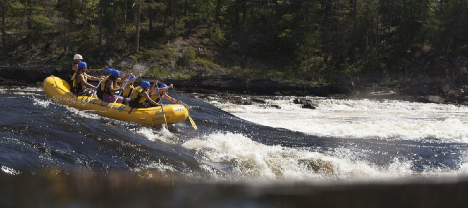 A group of people whitewater rafting.