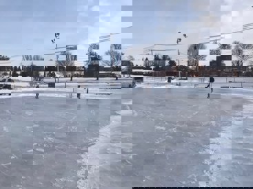 Kinsmen Park Outdoor Rink People skate on an outdoor rink.