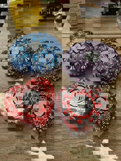 Tea light holders with dot painting on them.