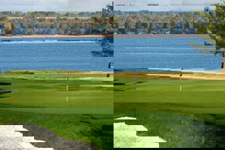 Pembroke Golf Club A golf green overlooking a river.